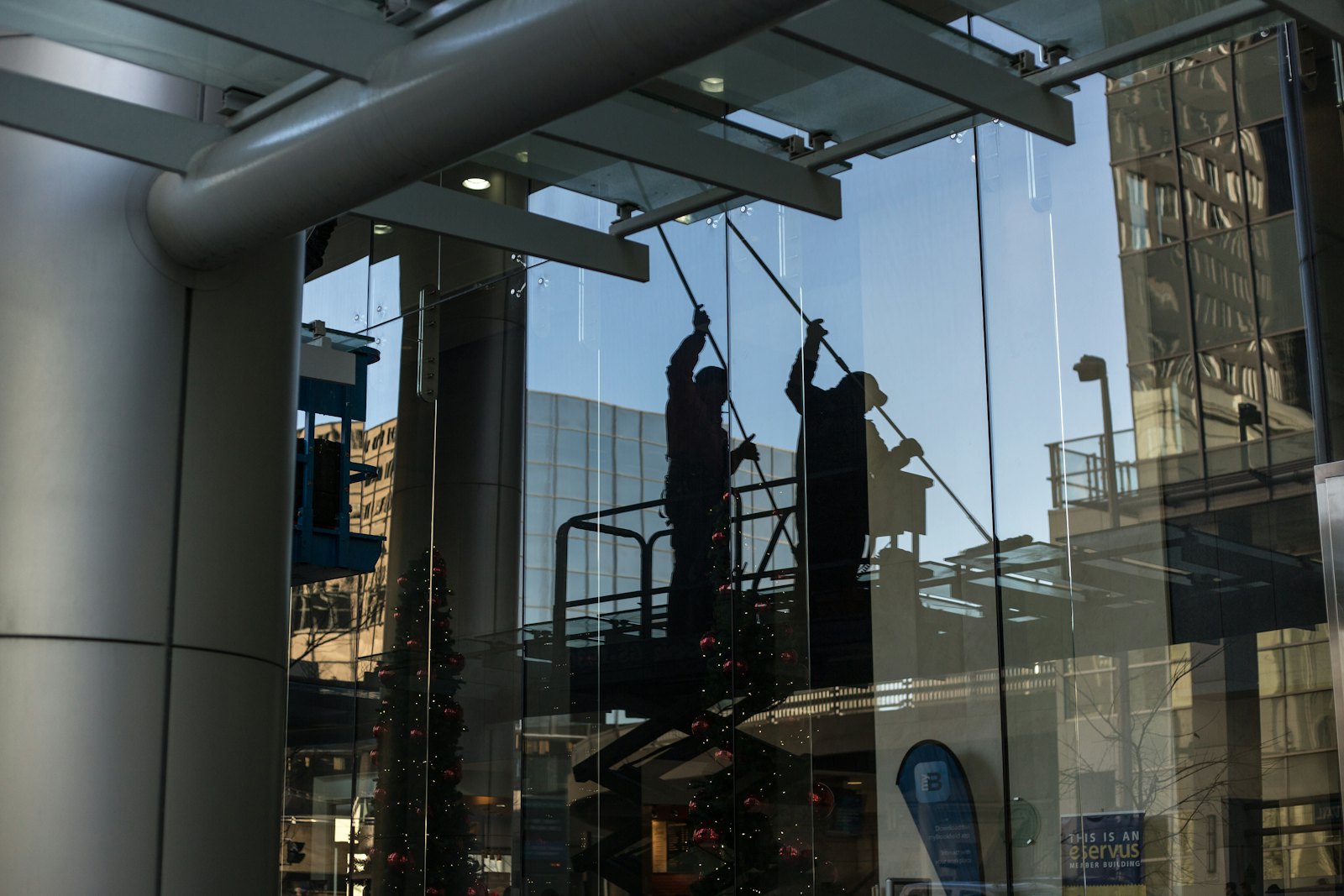 Technicians cleaning a glass facade